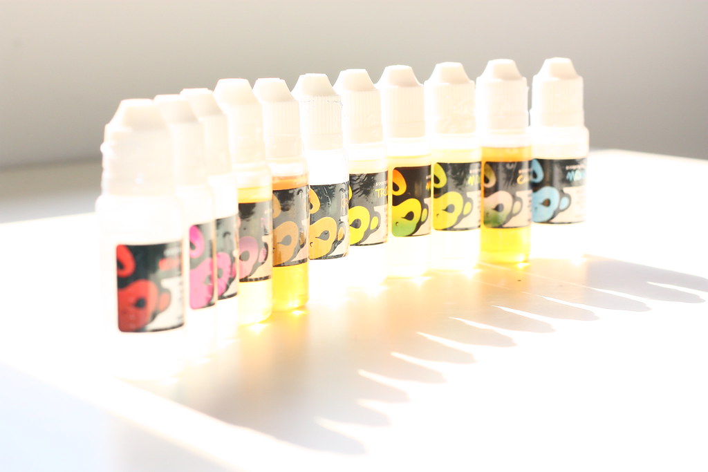 Row of flavored e-liquid bottles