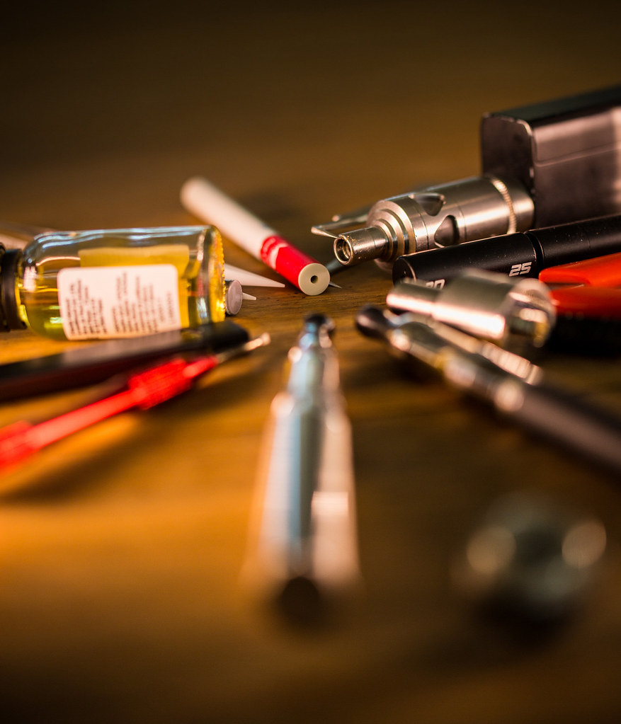 Assorted vaping devices and an e-liquid bottle
